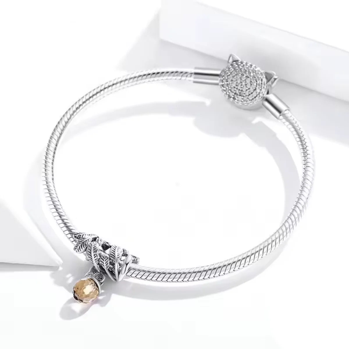 Showcase the beauty of nature with this intricate Acorn and Leaves Charm. Crafted from Sterling Silver, the charm highlights a detailed acorn surrounded by delicate leaf designs. Add this Pandora compatible charm to your collection and express your appreciation for the natural world.