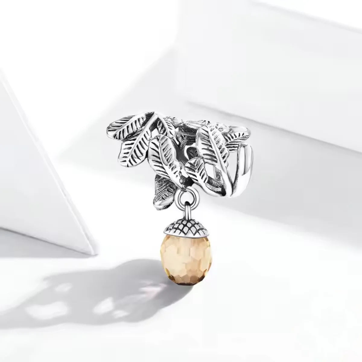 Showcase the beauty of nature with this intricate Acorn and Leaves Charm. Crafted from Sterling Silver, the charm highlights a detailed acorn surrounded by delicate leaf designs. Add this Pandora compatible charm to your collection and express your appreciation for the natural world.