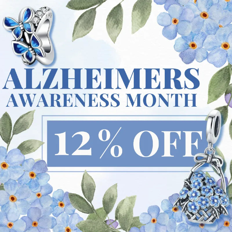 Promotional graphic for Alzheimer's Awareness Month featuring two silver jewelry charms with blue floral designs, set against a watercolor-style background of forget-me-not flowers and leaves with the text 'ALZHEIMERS AWARENESS MONTH 12% OFF'.