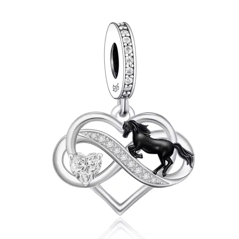 Embrace the spirit of freedom and strength with this Black Horse Heart Infinity Dangle Charm! Crafted in&amp;nbsp;sterling silver, this beautifully detailed charm features a black enamel horse galloping across an elegant infinity and heart design, symbolizing the unbreakable bond between a rider and their horse.