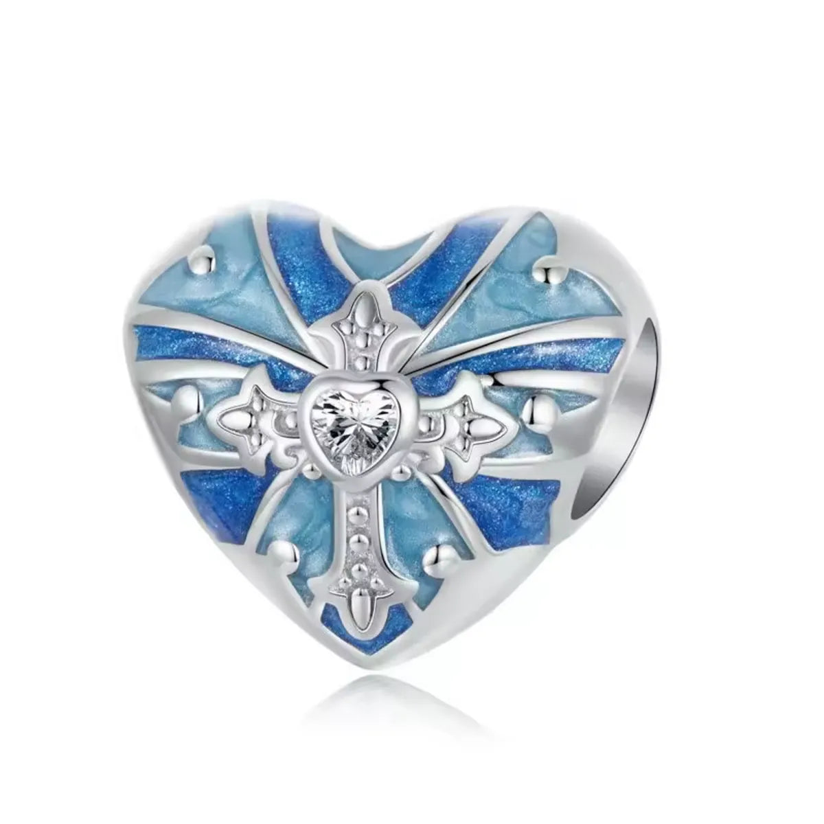 Heart-shaped silver charm with blue enamel and clear gemstone on a white background