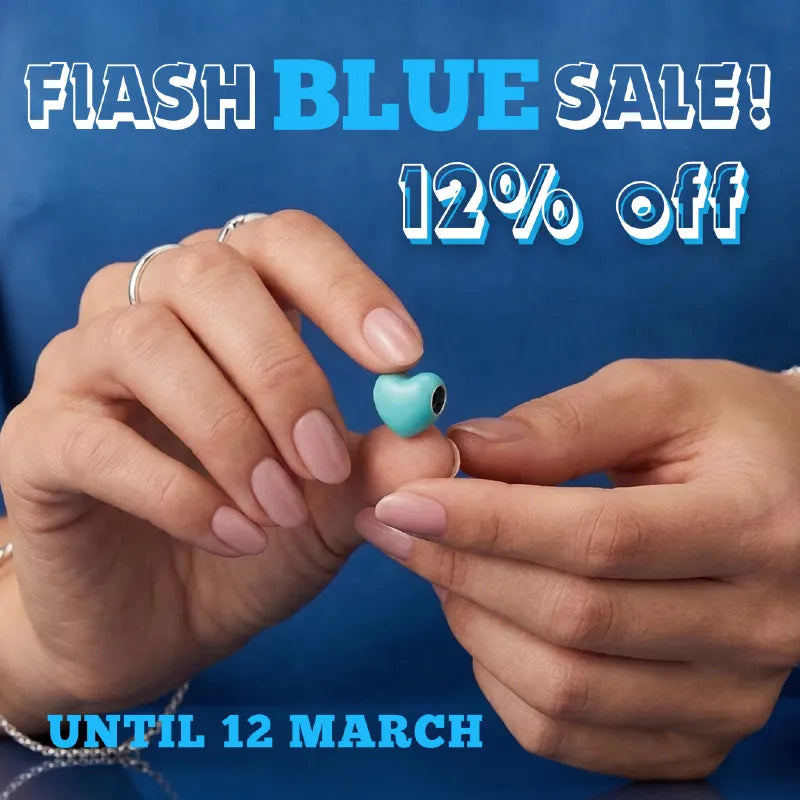 Person holding a small blue Charm with promotional text 12% Off for a flash sale on a dark background