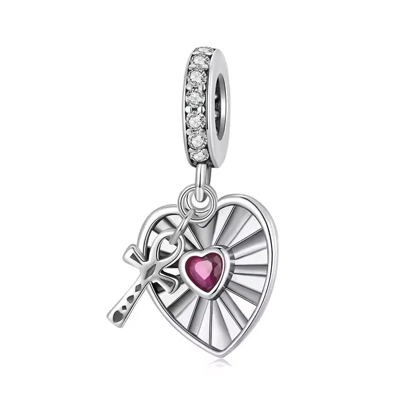 Heart and cross dangle charm in silver with ruby center and cubic zirconia for charm bracelets.