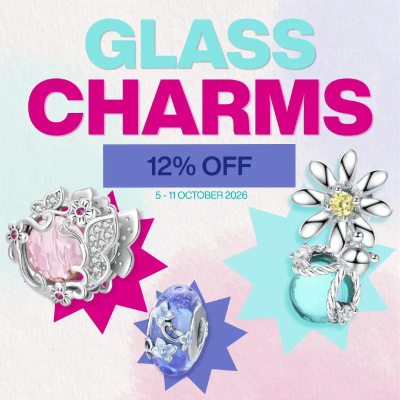 Promotional graphic for glass charms featuring three silver-toned jewelry charms with pink, blue, and light blue glass elements, set against a pastel gradient background with text reading 'GLASS CHARMS', '12% OFF', and '5 - 11 OCTOBER 2026'.