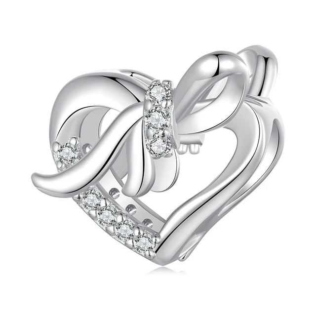 Delicate and refined, the Graceful Bowknot Heart Charm adds an elegant touch to your collection. Featuring a sparkling array of cubic zirconia, this charm radiates with brilliance, capturing the light at every angle. Its intricate heart design is adorned with a graceful bowknot