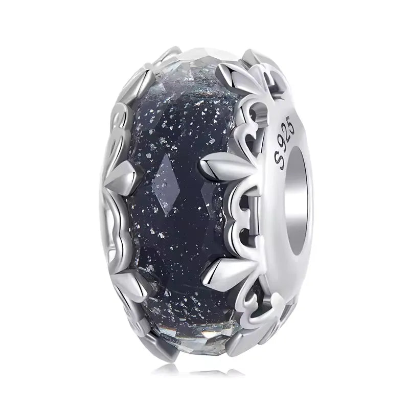 Midnight European Murano Glass Charm with navy blue glass and sterling silver leaf design, reflecting light beautifully.