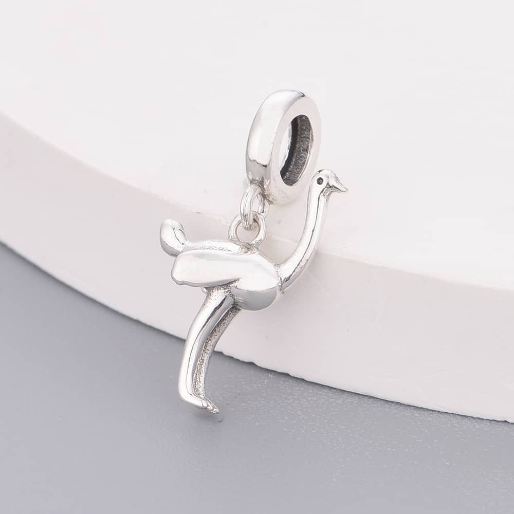 Step into the wild with this graceful Ostrich Dangle Charm! Featuring an elegant, minimalist design, this charm captures the beauty and strength of the world’s fastest-running bird in a sleek sterling silver finish. The detailed craftsmanship brings out the ostrich’s signature long neck and feathery form, making it a standout addition to any nature or animal lover’s jewelry collection.