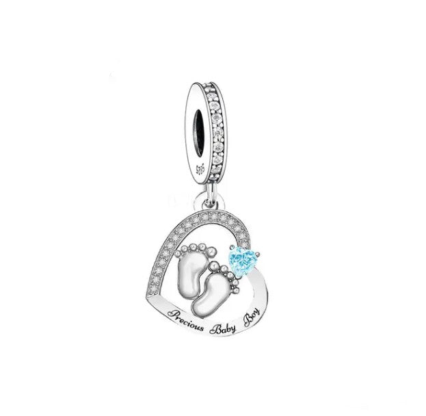 Celebrate the joy of parenthood with our adorable Precious Baby Boy Heart Dangle Charm. This delightful charm features a heart-shaped design adorned with a sweet baby boy footprints motif, making it the perfect addition to any new parent&#39;s charm bracelet. Crafted with attention to detail, this charm boasts sparkling cubic zirconia accents for added sparkle.