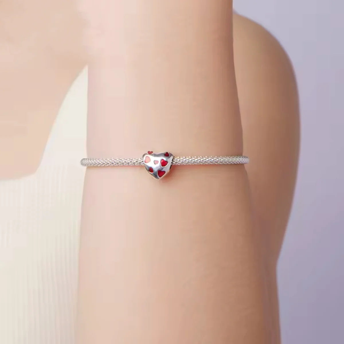 Fall head over heels with the Love-Filled Red Hearts Charm, a bold &amp; beautiful tribute to love in all its forms. This silver heart charm is sprinkled with rich red enamel hearts, each one full of passion and personality.