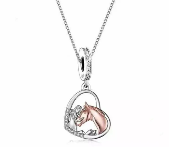 Sterling silver Girl Loves Horse Heart Dangle Charm with heart-shaped enamel and intricate horse design hanging from a Pandora bracelet chain