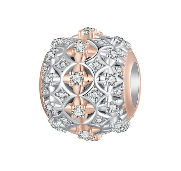 Two-tone round charm with sterling silver, rose gold plating, and sparkling cubic zirconia accents on a white background