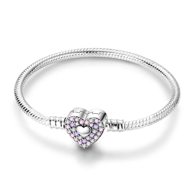 Celebrate the unbreakable bond of sisterhood with the beautiful Sisters Forever Bracelet. This stunning piece features a heart-shaped clasp adorned with shimmering pink cubic zirconia stones, symbolizing love, connection, and shared memories. Crafted from high-quality sterling silver, this bracelet is not only elegant but also Pandora-compatible, allowing you to personalize it with charms that reflect your unique story. Whether you gift it to a sister or a close friend, this bracelet is a timeless reminder 