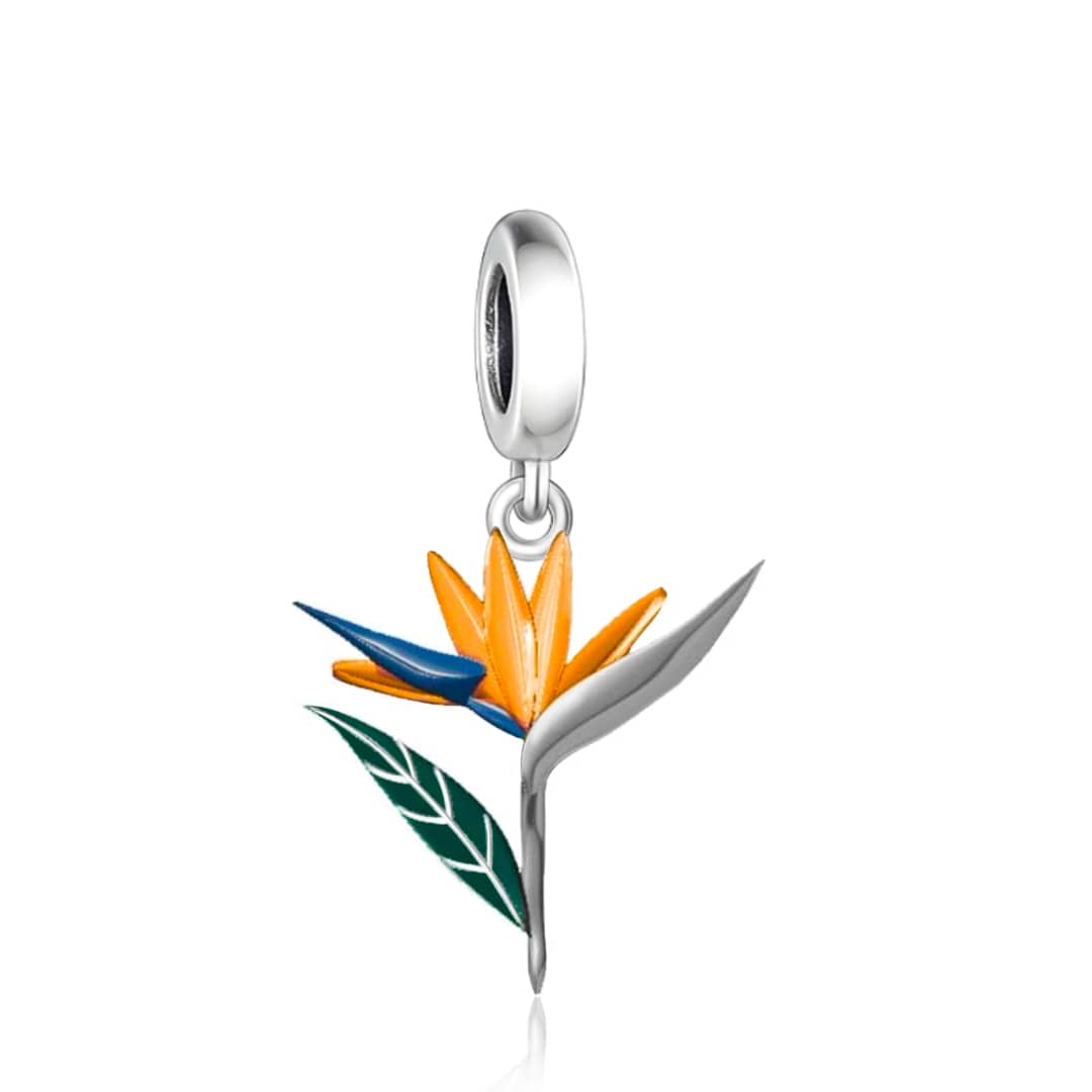Brighten up your jewelry collection with the stunning Strelitzia Dangle Charm! Inspired by the Bird of Paradise flower, this charm bursts with vibrant orange, blue, and green enamel accents, bringing the beauty of tropical gardens right to your wrist.
