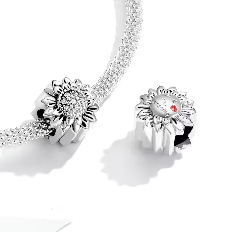 Brighten up your charm collection with this Sterling Silver Sunflower Charm. Featuring a detailed design with a lustrous center, this charm captures the beauty of this iconic flower. Compatible with Pandora bracelets and other popular charm bracelets, this sunflower charm is a beautiful addition to any collection.