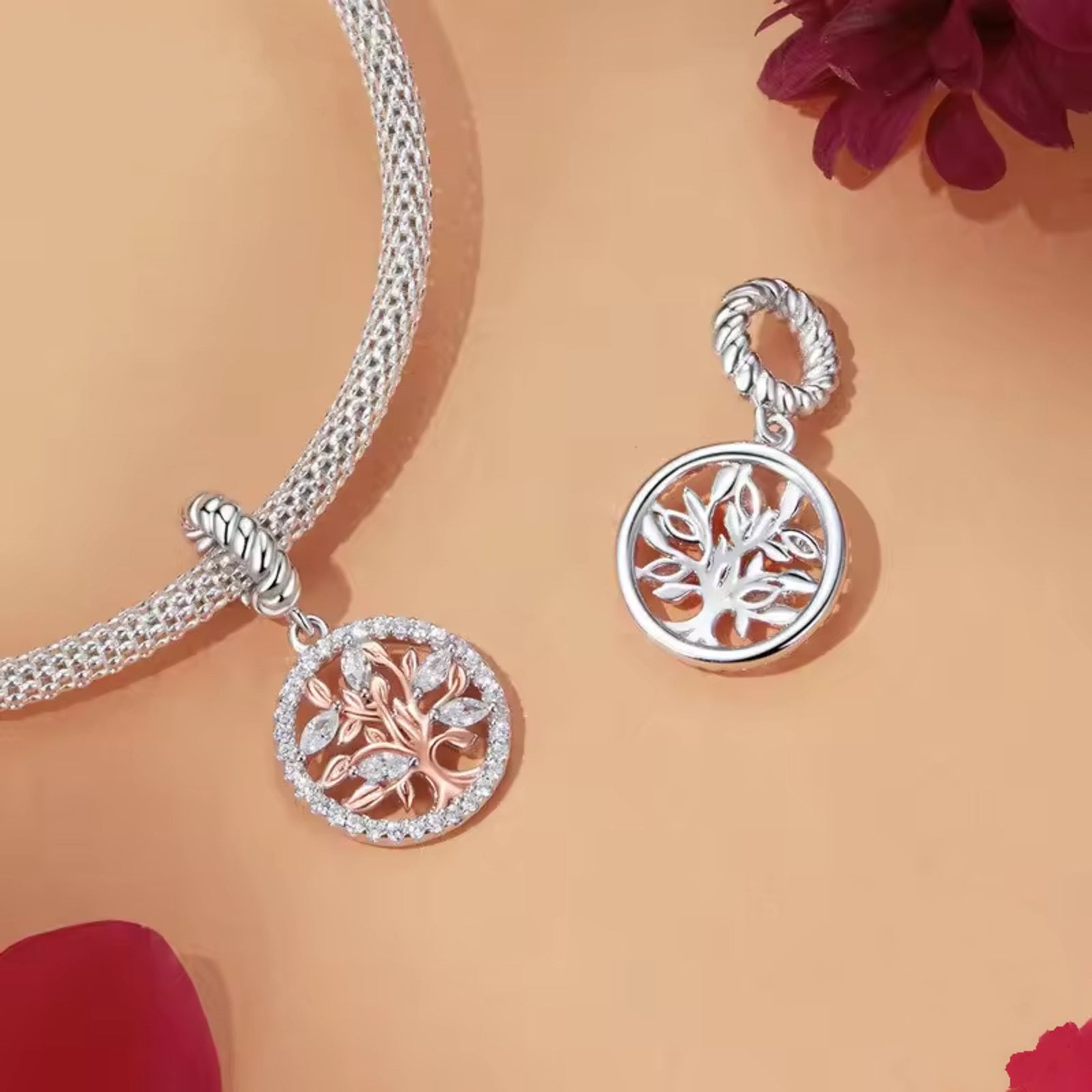 Silver necklaces with tree-of-life pendants on a peach background