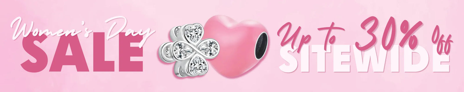 A pink promotional banner for a Women's Day sale, featuring the text 'Women's Day SALE' and 'Up to 30% Off SITEWIDE' alongside a pink heart charm and a silver-toned four-leaf clover charm.