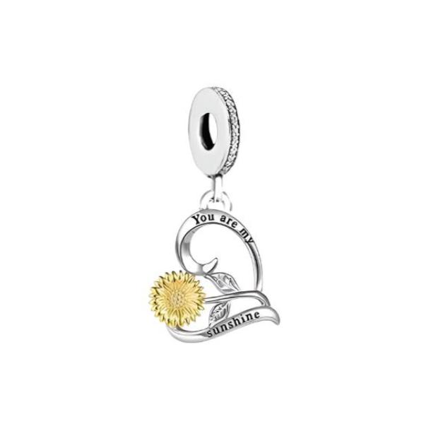 Add a touch of sunshine to your jewelry collection with this Gold Sunflower Heart Dangle Charm. Made of high-quality sterling silver with gold plating, this charm features a beautifully crafted sunflower design with sparkling cubic zirconia detailing. The heart-shaped charm is perfect for those who love romantic and meaningful jewelry. The oxidized words &quot;You are my sunshine&quot; add a personal touch and make this charm a perfect gift for someone special.
