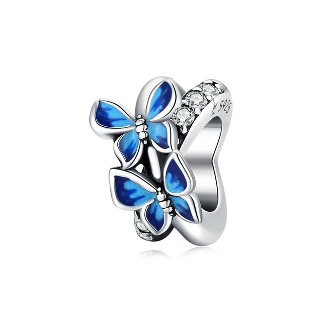 A sterling silver spacer with a blue butterfly design, compatible with Pandora charms.