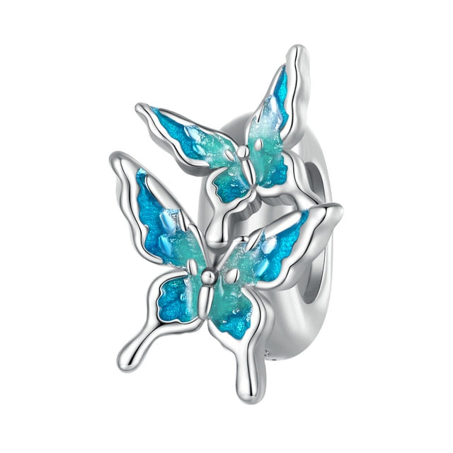 A sterling silver bracelet stopper featuring a design of blue butterflies with intricate details.