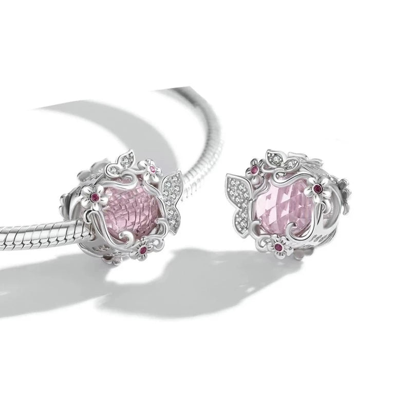 Transform your jewelry into a radiant garden with this Butterfly Blossom Pink Crystal Bead! Featuring a captivating pink crystal centerpiece surrounded by intricate butterflies and floral designs, this charm is the perfect blend of elegance and whimsy. Shimmering cubic zirconia accents add a dazzling sparkle, making this piece a standout addition to your charm bracelet.