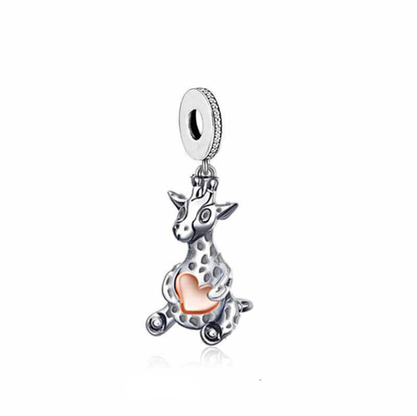 A silver-colored giraffe charm holding a heart-shaped pendant, likely made from metal.