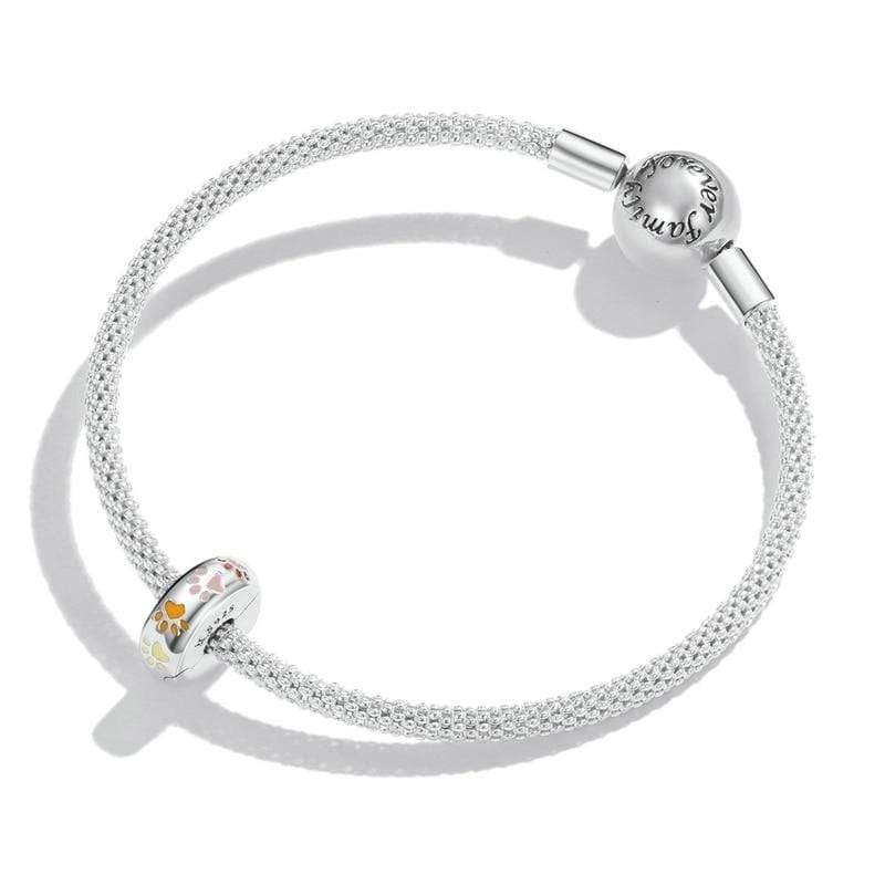 Celebrate the unconditional love of your furry friends with this adorable "Family Forever" Paw Clip. Designed for the person who treasures every paw print on their heart, this charm adds a playful and colourful touch to any bracelet. Featuring vibrant enamel paw prints in pink, red, orange, and yellow, it's a joyful reminder that pets are family too. The engraved "Family Forever" message makes it even more meaningful. Pandora-compatible and crafted from high-quality sterling silver, it's a must-have for any