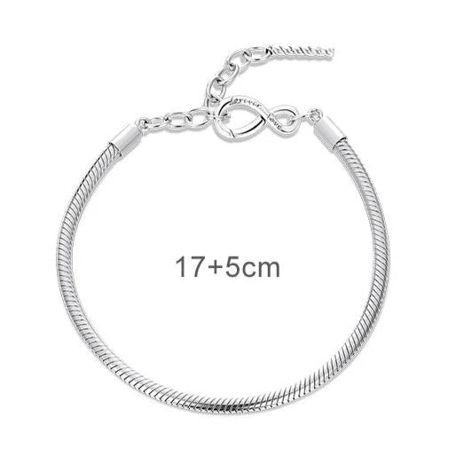 An adjustable sterling silver charm bracelet with an infinity symbol clasp, presented on a white background.