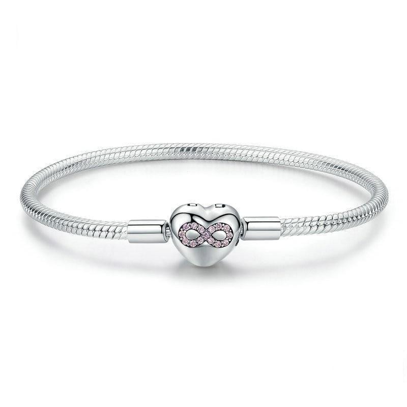 A silver bracelet with a heart-shaped clasp adorned with cubic zirconia.