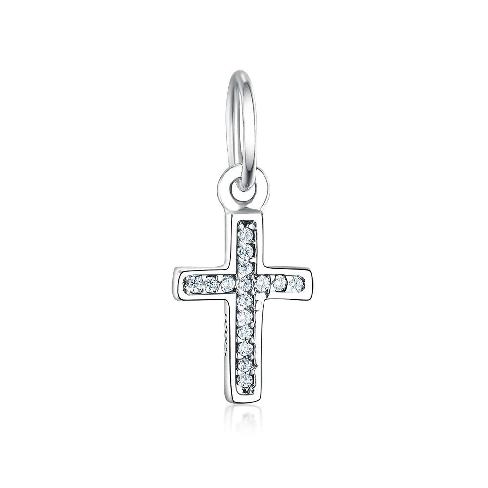 Express your faith with this elegant petite Cross Dangle Charm. Made of high-quality sterling silver, this Pandora-compatible charm features sparkling cubic zirconia on the cross, adding a touch of glamour to its classic design. This versatile charm is perfect for those who want to display their faith in a subtle yet stylish way.