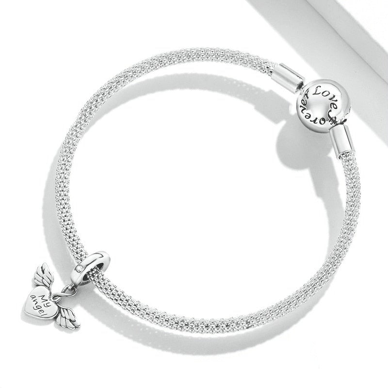 Keep your guardian angel close with our Petite My Angel Charm. Made from high-quality Sterling Silver and featuring a beautiful design, this charm is the perfect way to show your faith and belief in angels. With its intricate details and heartfelt message, this charm is sure to be treasured for years to come.