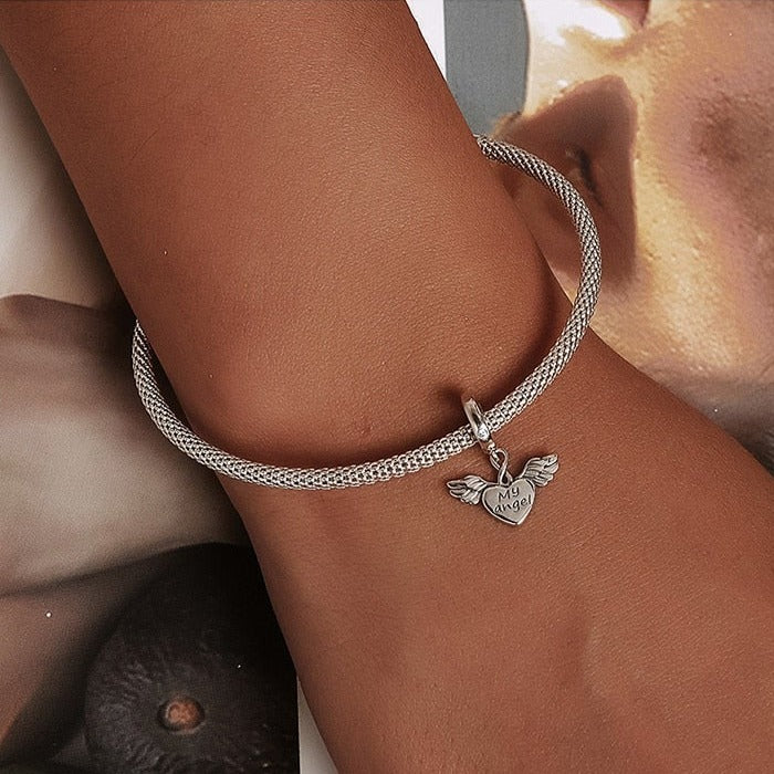 Keep your guardian angel close with our Petite My Angel Charm. Made from high-quality Sterling Silver and featuring a beautiful design, this charm is the perfect way to show your faith and belief in angels. With its intricate details and heartfelt message, this charm is sure to be treasured for years to come.