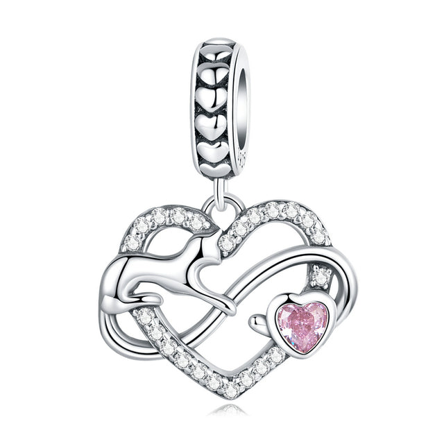 A sterling silver dangle charm featuring a playing kitten design with a pink heart and clear zirconia stones.