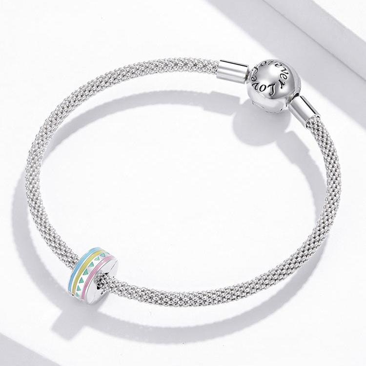 Add a splash of colour to your charm bracelet with this playful pastel clip! Featuring a delightful mix of pink, yellow, blue, and green enamel in a geometric pattern, this clip is perfect for securing your charms while adding a fun, stylish accent.