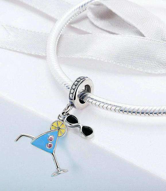 Stay cool this summer with this Summer Cocktail Dangle Charm. Featuring a fun and playful design with colourful enamel accents, this charm is perfect for anyone who loves to relax with a cold drink on a hot day, preferably on an island! Compatible with Pandora bracelets and other popular charm bracelets, this charm is a fun way to celebrate summer.