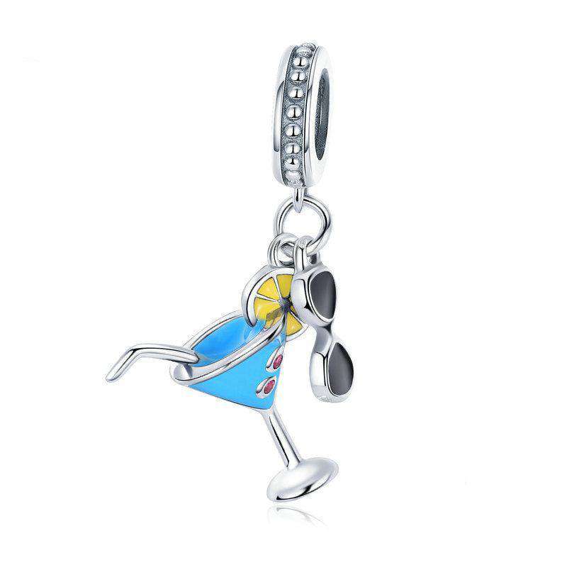 Stay cool this summer with this Summer Cocktail Dangle Charm. Featuring a fun and playful design with colourful enamel accents, this charm is perfect for anyone who loves to relax with a cold drink on a hot day, preferably on an island! Compatible with Pandora bracelets and other popular charm bracelets, this charm is a fun way to celebrate summer.